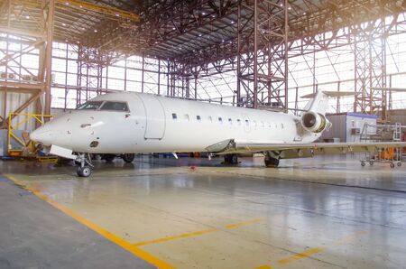 White aircraft in the hangar on a large-scale inspection, repairの写真素材