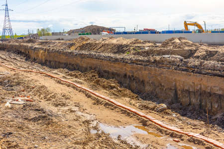 A trench dug in the ground on a city street during the construction of a highway