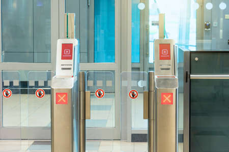 Red Cross the passage is closed sign Empty gateway terminal area in airport, closed boarding gate...