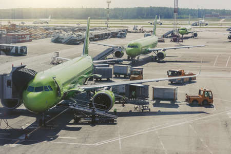 Several planes on the large apron of the international airport