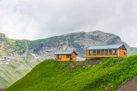 Two wooden houses on top of a mountain
