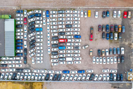 Dealership parking lot, many cars top aerial view