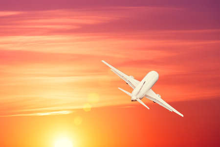 Plane is taking off at sunset bright sky