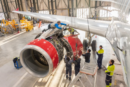 Specialist mechanic repairs the maintenance of a large engine of a passenger aircraft in a hangar. Russia. Moscow. 28 november 2018のeditorial素材