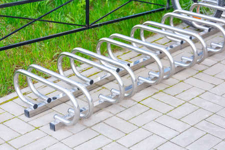 Empty metal bike rack in parking lot of campusの写真素材
