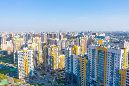 Panoramic aerial view of the city with multi-storey residential buildings and highwaysの写真素材