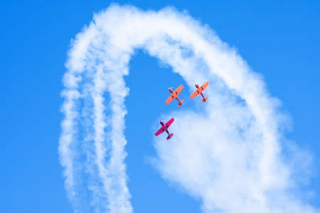 Light engine airplanes perform aerobatics in a cloud of smoke