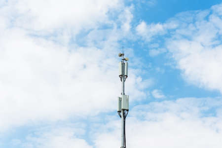 Cellular macro Base Transceiver Station. Telecommunication tower. Wireless Communication Antenna Transmitter. Development of communication systems in urban area skyの写真素材