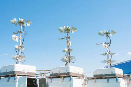 Three powerful mobile antennas on the roofs of a van car for communication or location observation in the immediate radius of the space, mobile point of movementの写真素材