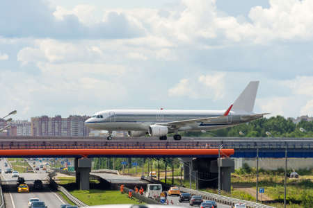 Passenger plane crosses the steering track of a motorwayの写真素材