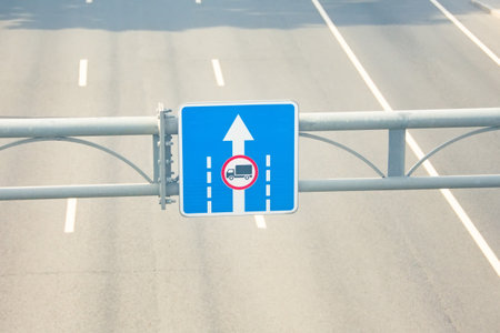 Road sign above the highway, no lane for trucks