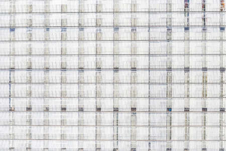 Aerial top view of large industrial greenhouses, glass texture, frame