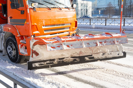 Snow plow truck on road pushing the snow on the sideの写真素材