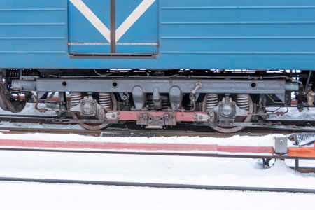 Wheelset near a subway car with a pantograph on a contact rail in winterの写真素材