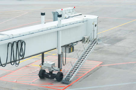 Airbridge, jet bridge, ladder lonely at an empty parking lotの写真素材