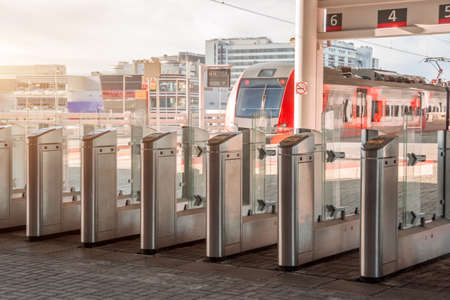 Turnstiles for presenting and scanning tickets on the platform of public railway train transport.