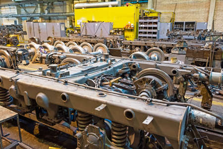 Carriage bogie and wheelsets and train engines under repair in the workshopの写真素材