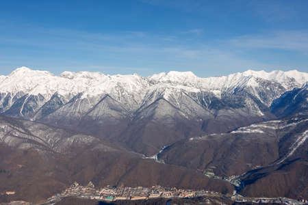 Mountain panorama in winter time and sunny day, below a small town in the gorge