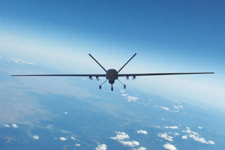 Air Force unmanned aerial vehicle with military equipment flying near base, straight front viewの写真素材