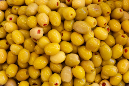 Pickled olives laid out in an even layer, juicy delicious color. Food texture backgroundの写真素材