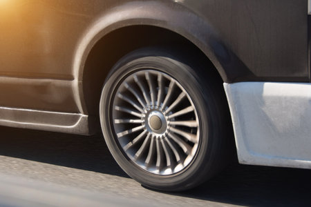 Transport, driving and motor vehicle, close up detail of wheel, tire and breaks dirty blue car parking on asphalt roadの写真素材