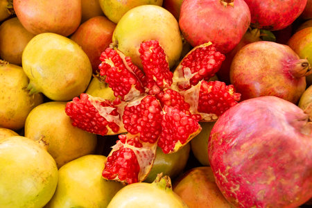 Pomegranate fruits broken into slices with inner red juicy seedsの写真素材