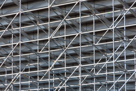 Metal pipe frame structure. Industrial construction from tubes raises upwards. Building process and...