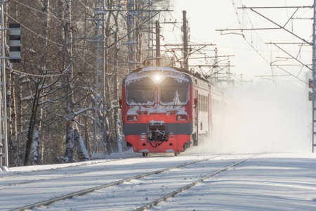 Express obsolete electric train rushes lifting snow into the air winter landscapeの写真素材