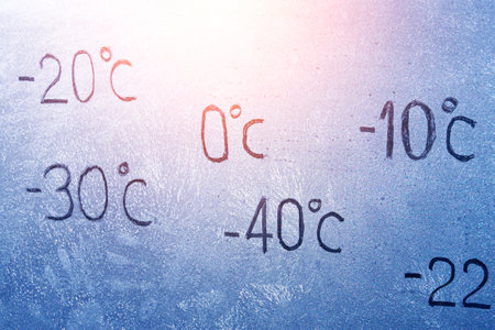 degrees -10 -20 -30 - 40 0 Celsius number lettering on icy glass covered with ice and frost. The concept of extreme cold weatherの写真素材