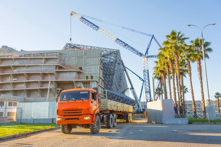 Truck with a trailer arrived to unload building materials at a construction siteの写真素材