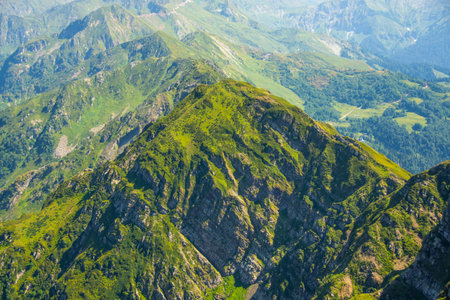 View from a height on the slopes of the mountains of the pass ridge covered with vegetation, a beautiful natural landscapeの写真素材