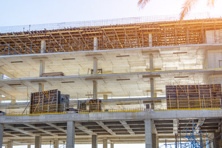 Concrete frame of tall apartment building under construction in a cityの写真素材