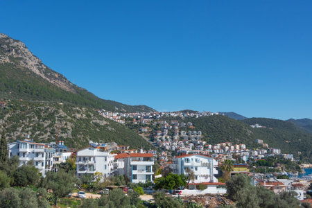 Majestic panoramic view of seaside resort city of Kas in Turkey. Hillside with traditional houses in the city, Villas and hotels with red roofs are open for touristsの写真素材