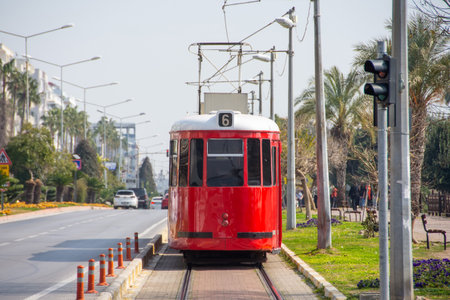 Retro red tram on route route line in city streetの写真素材