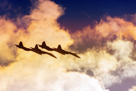 Group of four aircraft fighter jet airplane speed combat mission sun glow toned gradient clouds sky.
