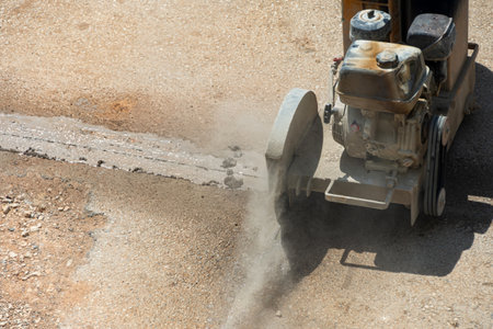 Cutting road works with petrol driven angle grinder