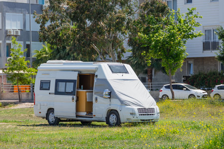 Mobile home on wheels van parked in the street on the meadow of the city parkの写真素材