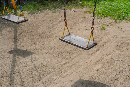 Empty chain old swing in playground.の写真素材