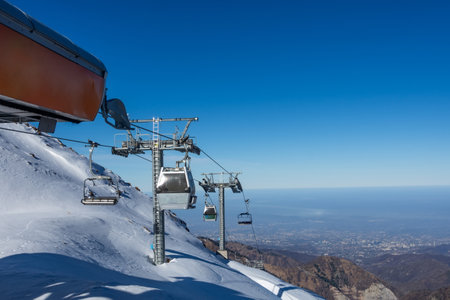 Cable car reaching the modern mountain station highest peak range in winter. Panoramic view.の写真素材