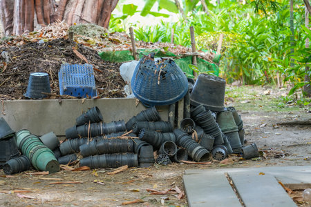 Heap of waste garbage dump with pots and leaves of dried plants in rural areas of agro-industrial...