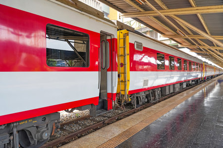 Passenger cars white red color of the train on the platform of the railway station
