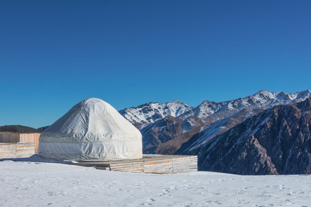 National house of the peoples of and Asian countries. Yurts on the background of snow peaks mountains and highlands. Yurt camp for touristsの写真素材