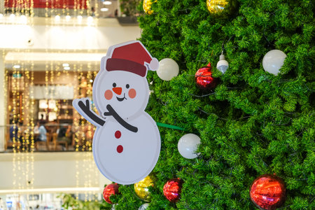 Snowman toy in a red hat decoration on the New Year treeの写真素材