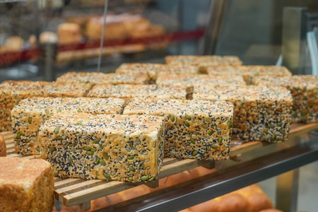Bread baking seeds, pumpkin, sunflower and sesame. Fresh pastries on a store windowの写真素材