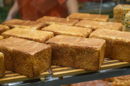 Several loaves of bread on the counter in a bakery storeの写真素材
