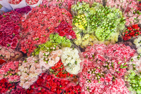 Many bouquets of flowers of various colored red pink and white shades of chrysanthemum and carnation flowersの写真素材