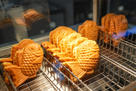 Waffle taiyaki fish pastries on display at a coffee shopの写真素材
