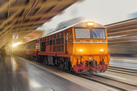 Locomotive diesel passenger train departs from the station speed motion blur.の写真素材