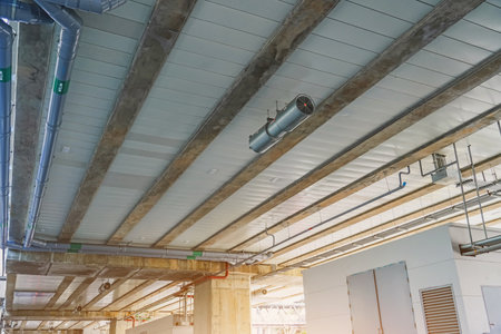 Ceiling with water supply and drainage communication pipes under the bridge support station platformの写真素材