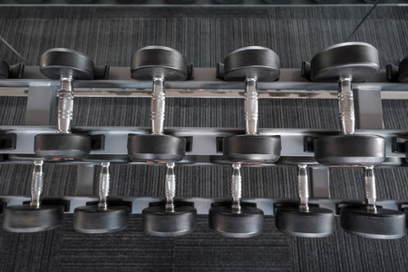 Rows of dumbbells in the gym of modern dumbbells equipment in the sport, top view.の写真素材